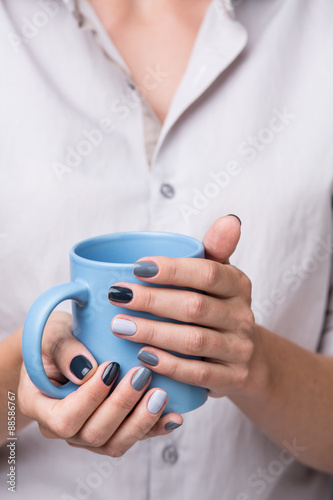 Female hands with blue cup