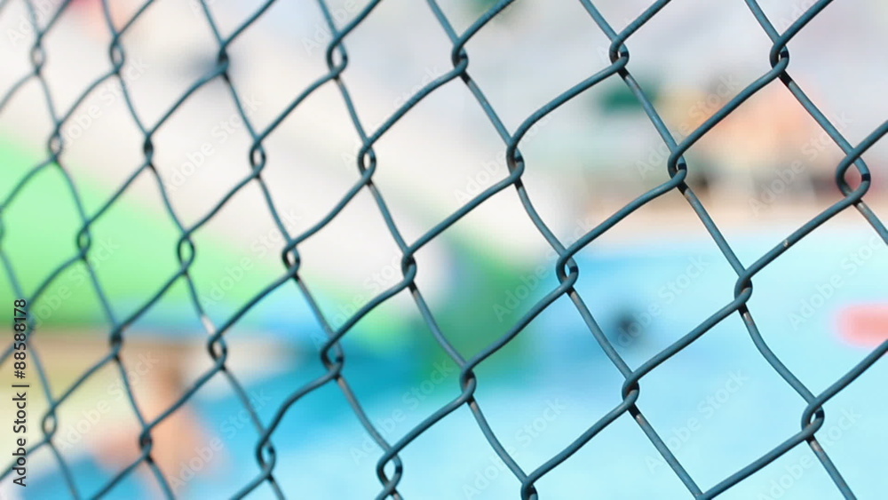 blurry water park behind a fence blurry water park behind a fence