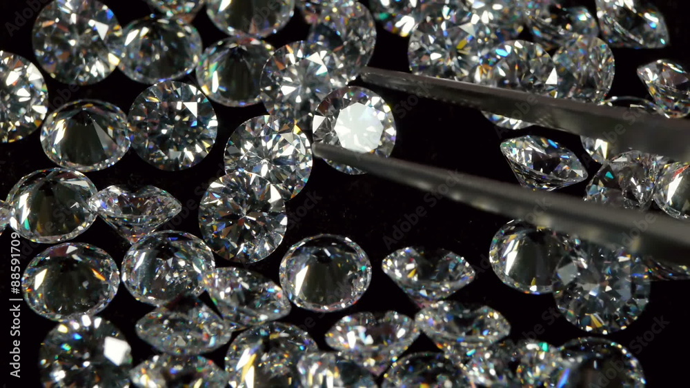Selecting a Clear White Diamond With Pincers. Selecting a Clear White Diamond With Pincers.