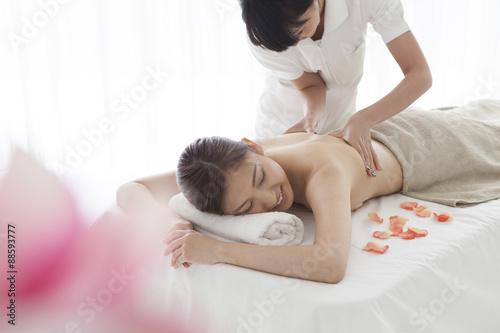 Young women are receiving oil massage