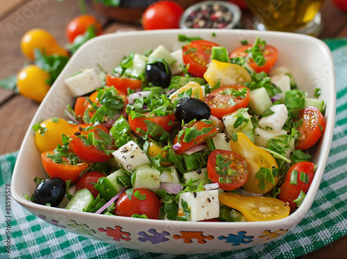 Greek salad with fresh vegetables, feta cheese and black olives