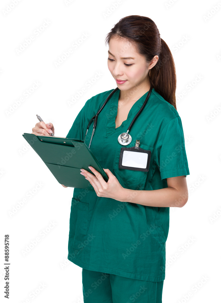 Female doctor take note on report Female doctor take note on report