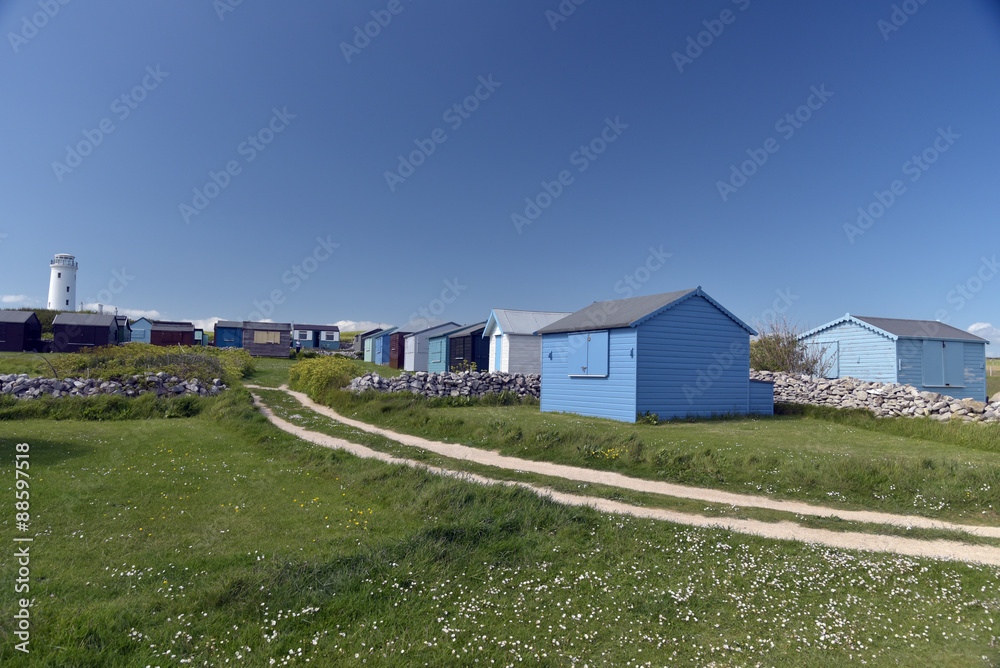 Lighthouse and beach huts at Portland Bill on Dorset coast Lighthouse and beach huts at Portland Bill on Dorset coast