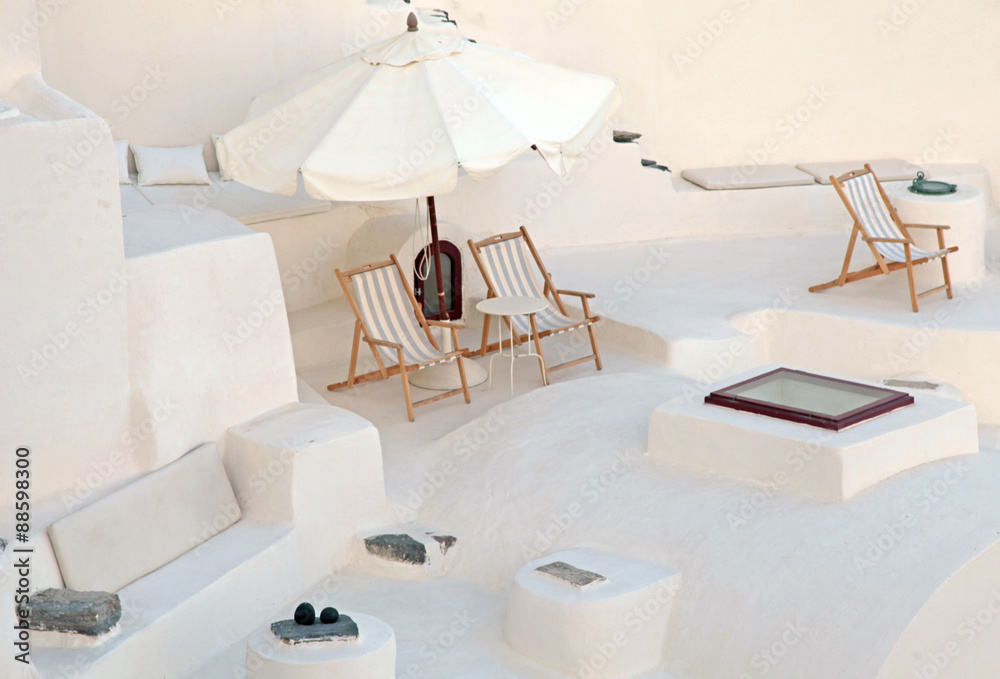White terrace with deck chairs in caldera house, Santorini, Greece White terrace with deck chairs in caldera house, Santorini, Greece