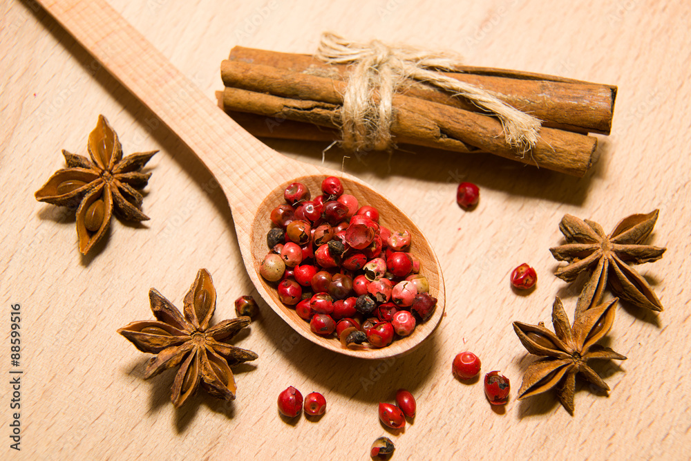 Spoon with a mixture of grains of pepper, cinnamon and star anis Spoon with a mixture of grains of pepper, cinnamon and star anis