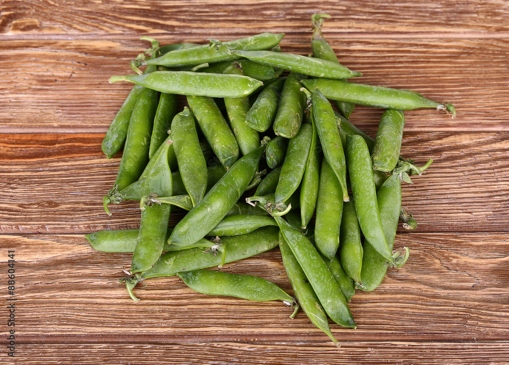 Green peas on wooden background.top view Green peas on wooden background.top view