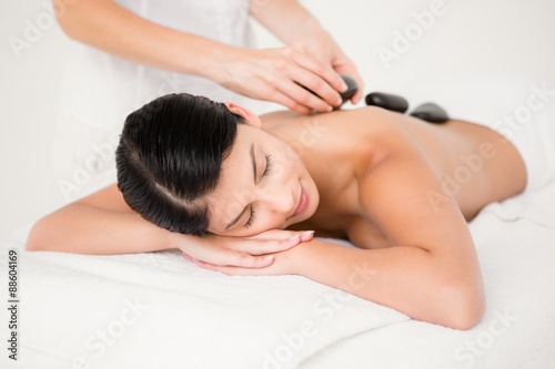 Pretty woman receiving a hot stone massage