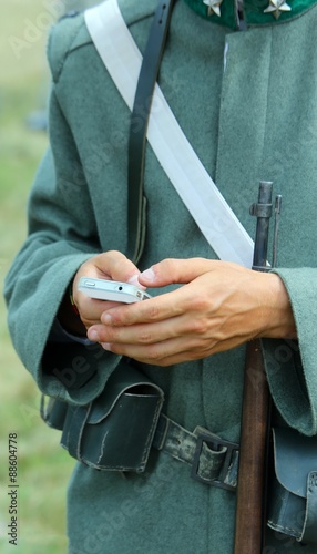 Rifle and Smartphone of a soldier during reenactment of a battle photo