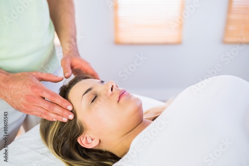 Relaxed pregnant woman enjoying head massage