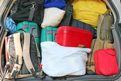 car overloaded with suitcases and duffle bag for family travel