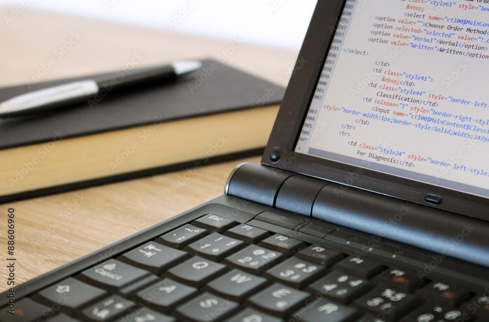 Coding a website on modern notebook at office Coding a website on modern notebook at office