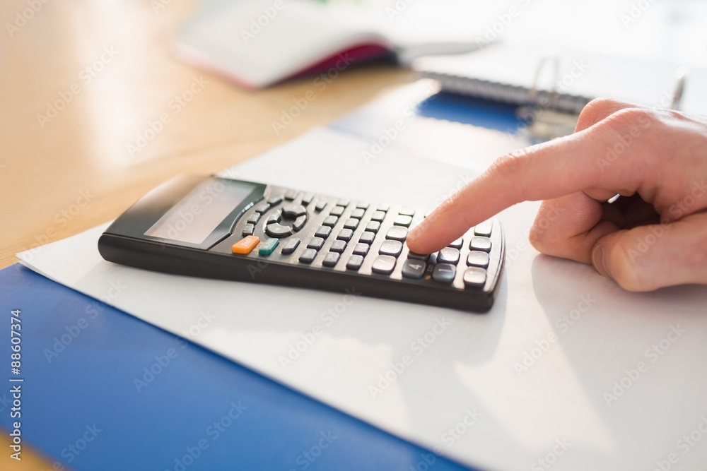 Businessman hands typing on calculator Businessman hands typing on calculator