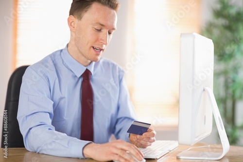 Businessman shopping online at desk