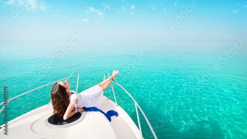 Woman lying on a private yacht in the sea.