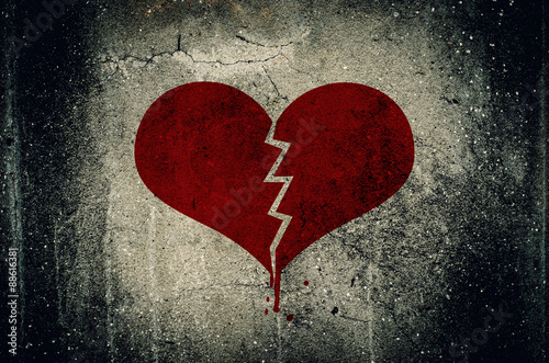 Heart broken painted on grunge cement wall background - love con