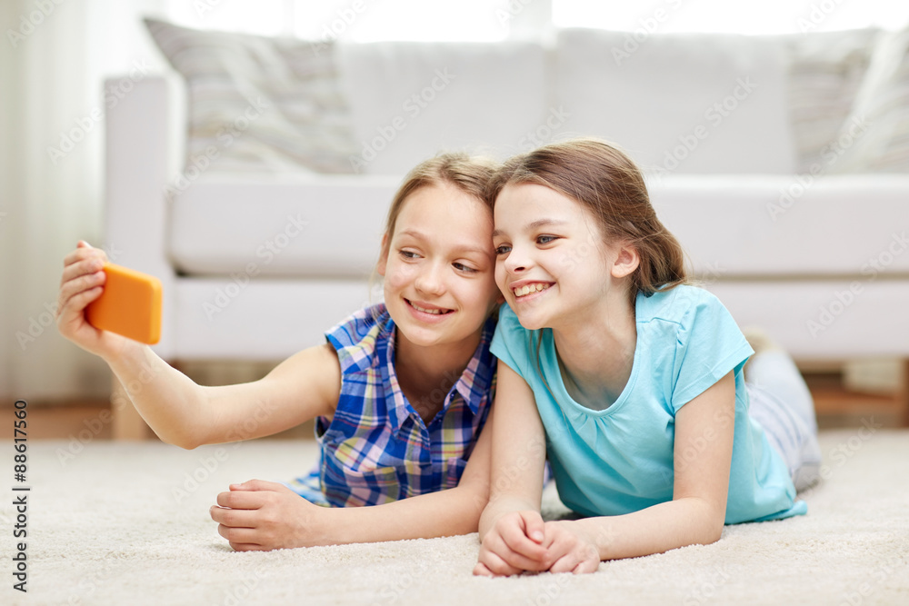 happy girls with smartphone taking selfie at home happy girls with smartphone taking selfie at home