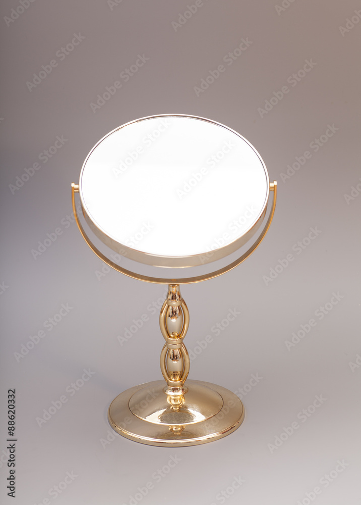 Golden mirror isolated on gray background Golden mirror isolated on gray background