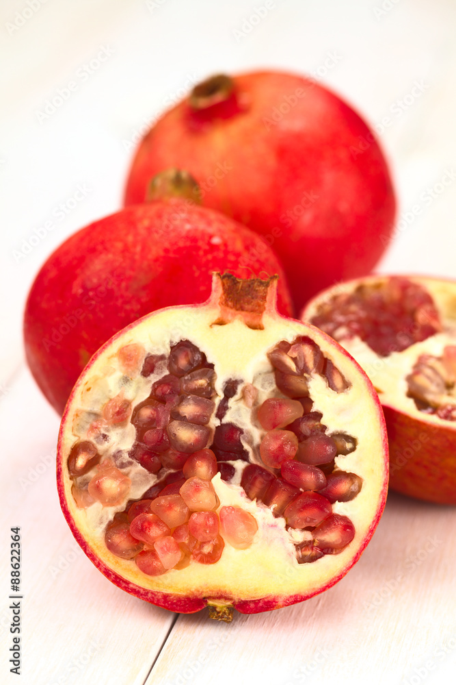 Pomegranate fruits (lat. Punica granatum) (Selective Focus, Focus on the seeds in the front) Pomegranate fruits (lat. Punica granatum) (Selective Focus, Focus on the seeds in the front)