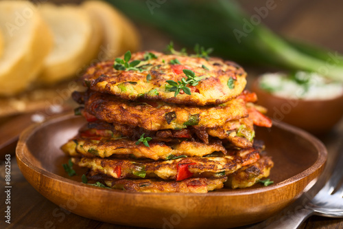 Photography Vegetable and egg fritter made of zucchini, red bell pepper, eggs, green onions