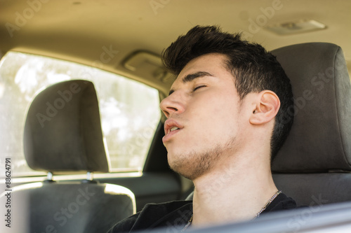  Young man sleeping at the wheel driving his car