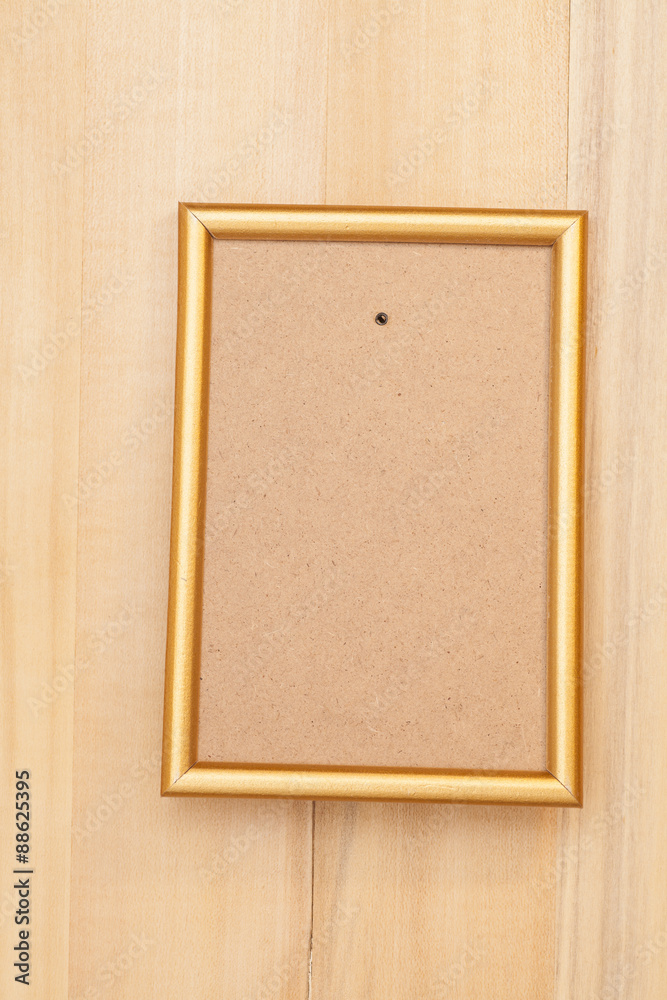 Fototapeta premium Empty golden picture frame on wooden background