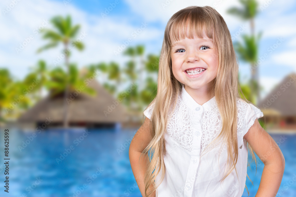Little blonde girl near the pool in tropical resort Little blonde girl near the pool in tropical resort