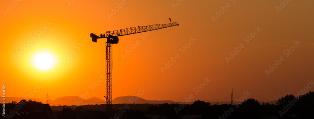 Fototapeta premium Tower crane in the sunset