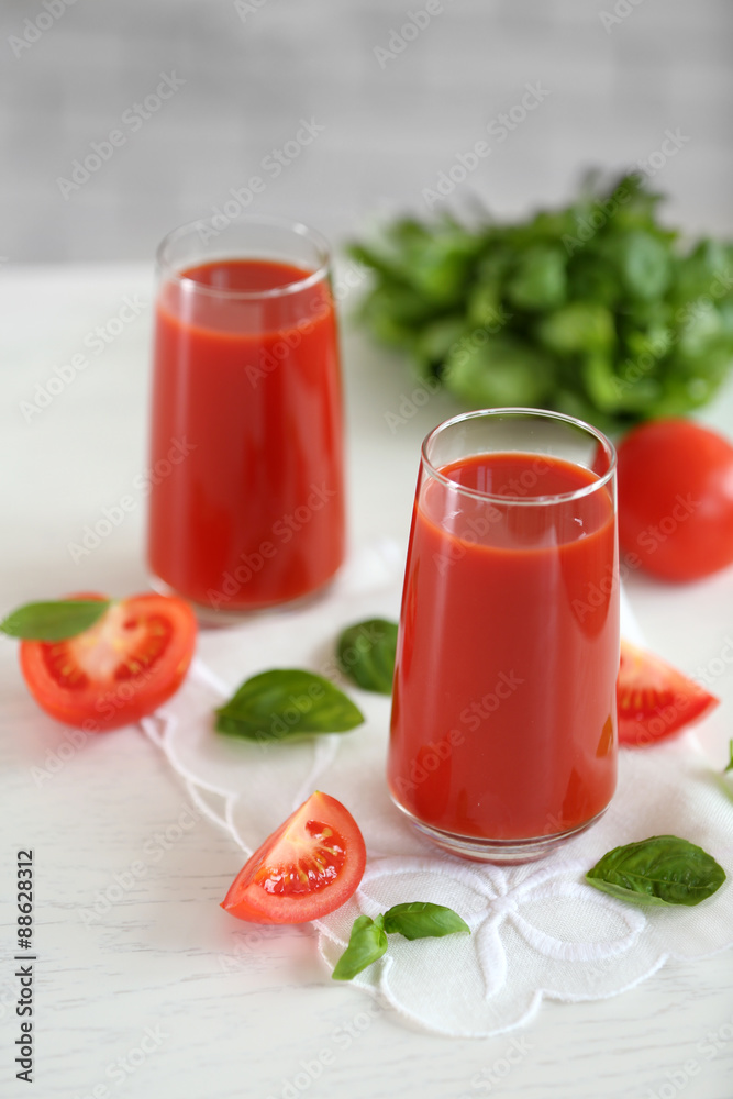 Tomato juice and fresh tomatoes on wooden table close-up Tomato juice and fresh tomatoes on wooden table close-up