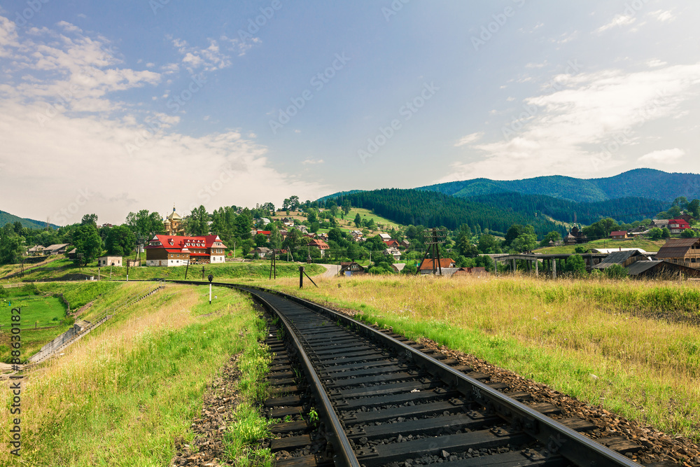 Fototapeta premium railway through a village in Carpathians