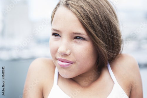 Young long-haired teen girl standing on the beach