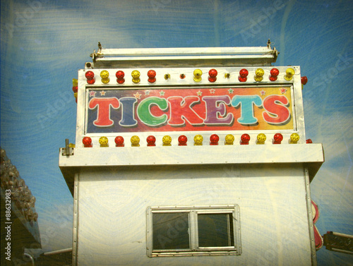 aged and worn vintage photo of ticket booth at carnival