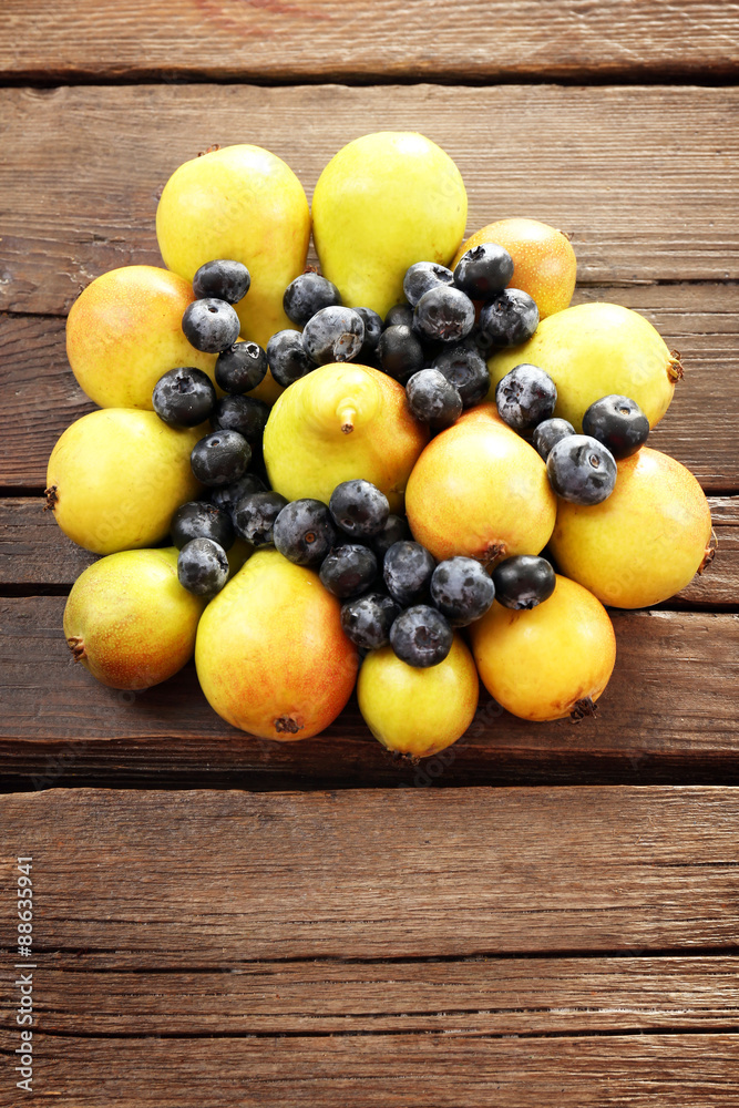 Ripe pears and blueberries on wooden table close up Ripe pears and blueberries on wooden table close up