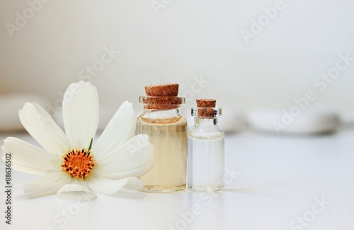 liquid organic cosmetic product bottles creamy fresh flower white background bathroom shelf sunlit attar tonic beauty care photo