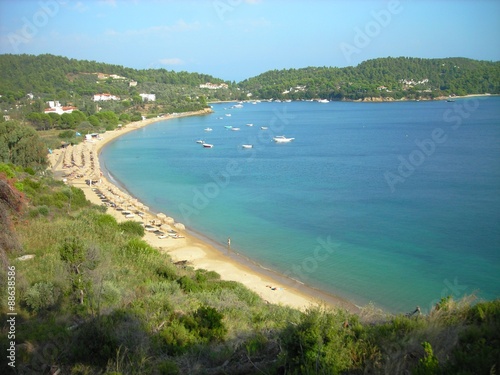 Panoramic view on the transparent blue waters of the Agia Paraskevi beach on the Greek island of Skiathos, in the Aegean sea, on a sunny day.