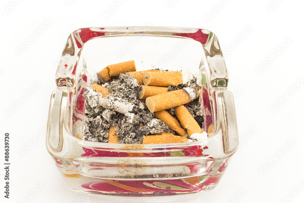 Glass ashtray with cigarette butts, isolated on white Glass ashtray with cigarette butts, isolated on white