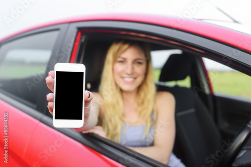 Driver woman showing her smartphone.