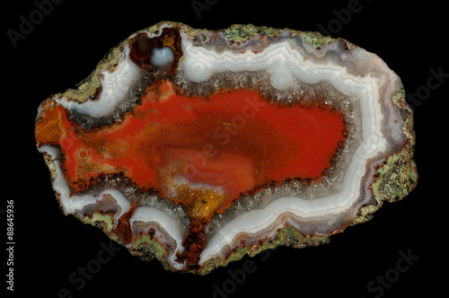 A cross section of agate stone on a black background. Origin: Morocco, Atlas Mountains