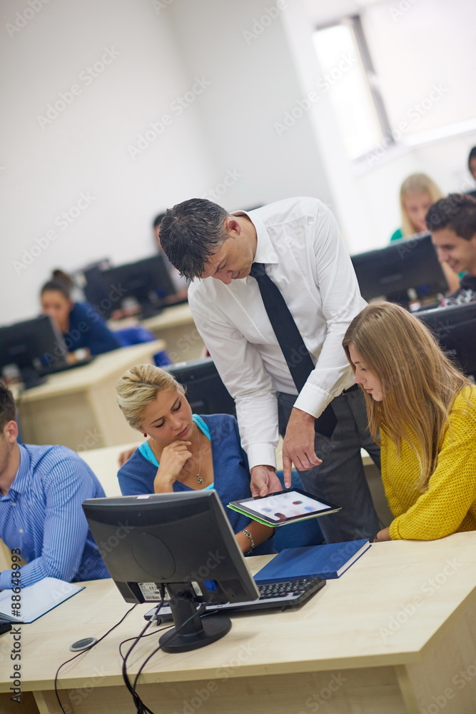 students with teacher  in computer lab classrom