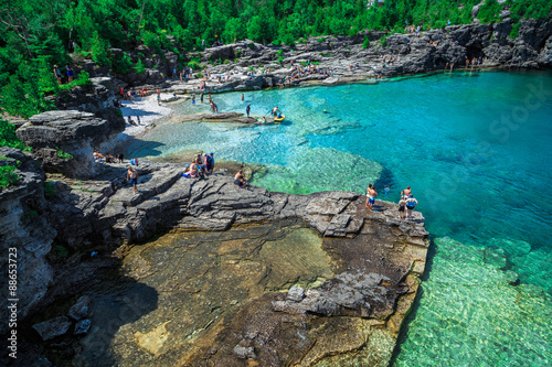 Bruce Peninsula at Cyprus lake, Ontario stunning, gorgeous amazing natural rocky beach view and tranquil azure clear water with people in background