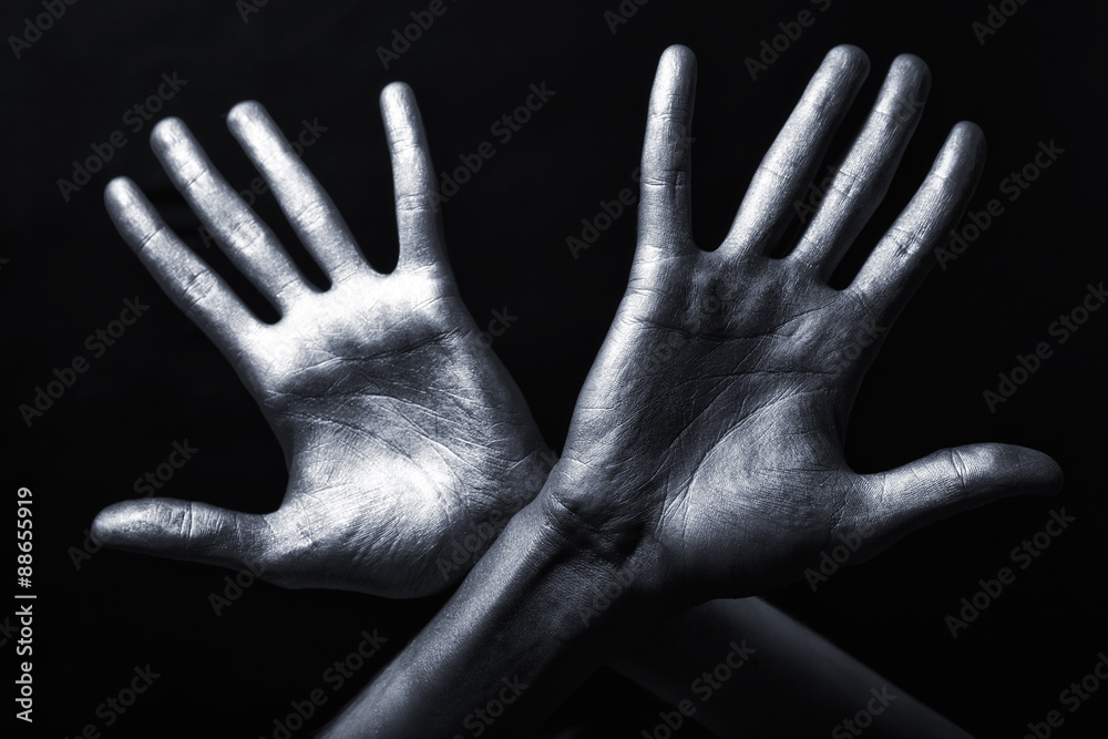 hand in a silver paint isolated on black background hand in a silver paint isolated on black background
