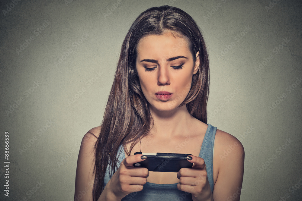 woman unhappy, annoyed by something, someone on her cell phone texting woman unhappy, annoyed by something, someone on her cell phone texting