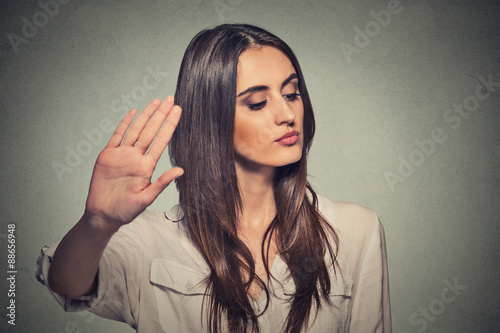 annoyed angry woman with bad attitude giving talk to hand gesture