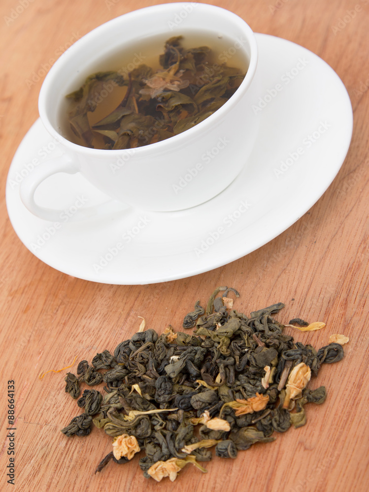 green tea with jasmine on a wooden background green tea with jasmine on a wooden background