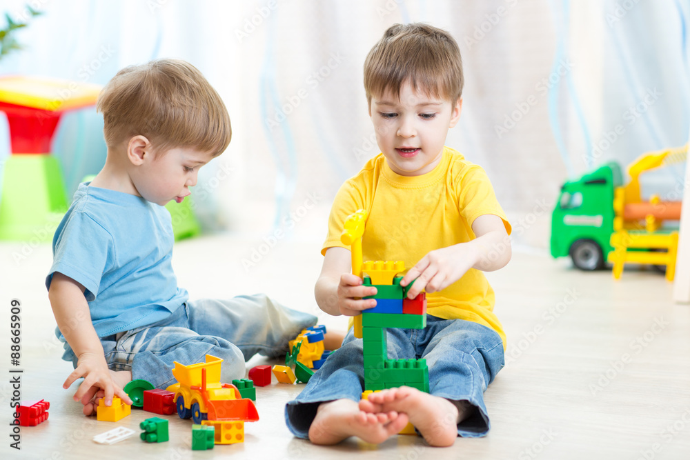 Kid boy playing with little brother at home Kid boy playing with little brother at home