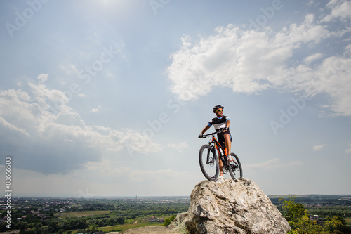 the guy with the bike on top of the mountain