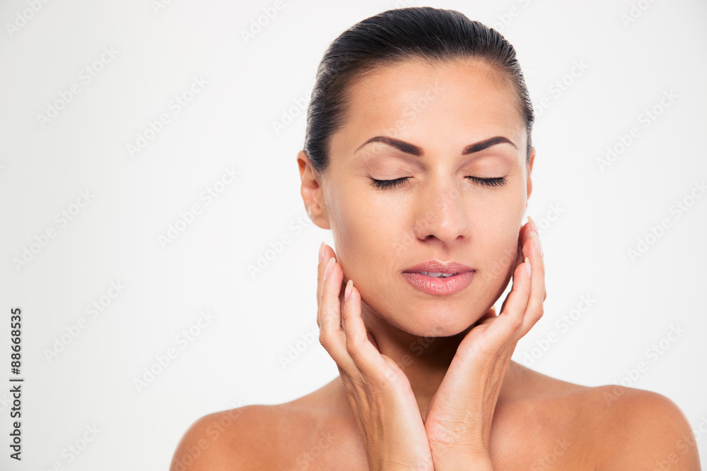 Woman with closed eyes touching her face Woman with closed eyes touching her face