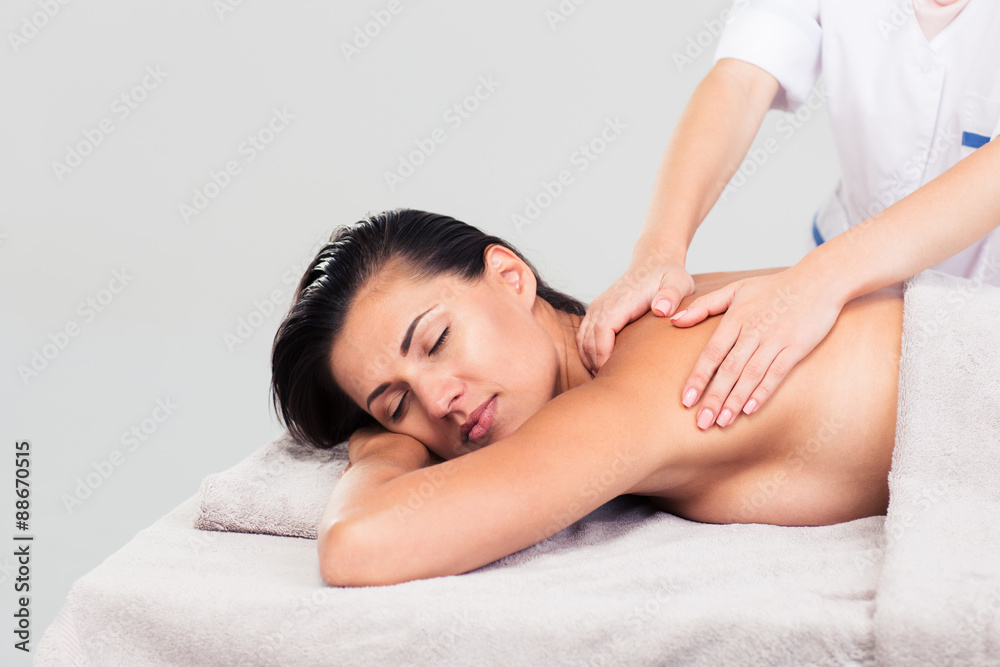 Woman lying on massage lounger Woman lying on massage lounger
