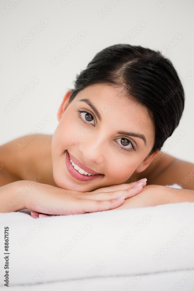 Pretty brunette enjoying a massage smiling at camera Pretty brunette enjoying a massage smiling at camera