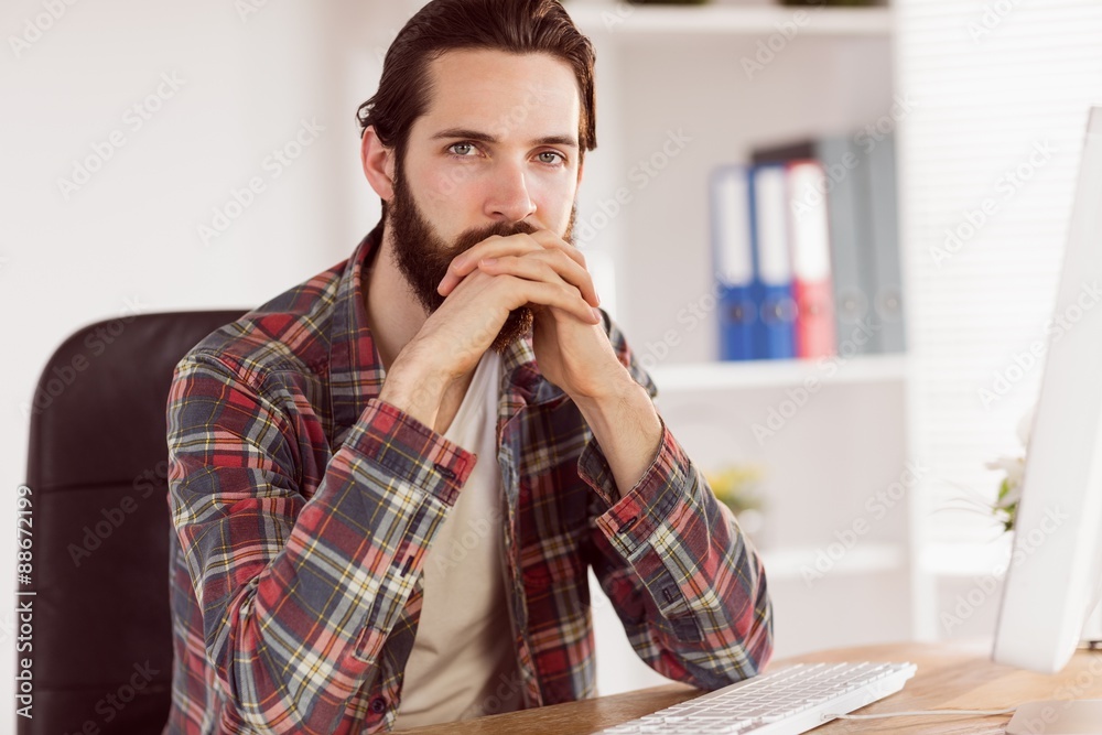 Hipster businessman sitting at his desk Hipster businessman sitting at his desk