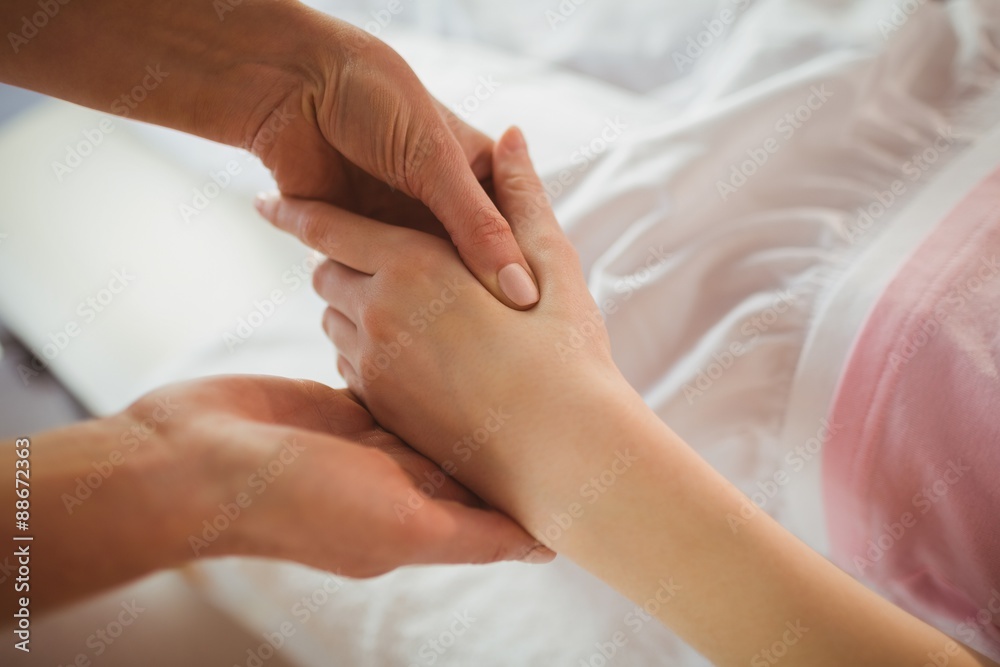 Young woman getting hand massage Young woman getting hand massage
